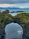 Stone arch called Gatklettur between the villages of Arnarstapi and Hellnar