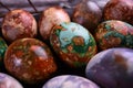 Naturally painted Easter eggs in a black clay plate on a rustic wooden background Royalty Free Stock Photo