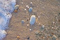 Naturally rounded gravel at sea shore, nature sea background tex