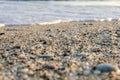 Naturally rounded gravel at sea shore, nature sea background texture