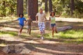 Nature, adventure and group of kids in forest playing, running and exploring together. Bonding, field and young children Royalty Free Stock Photo