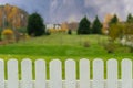 Nature autumn background with white wooden fence and green grass, blurred fall landscape Royalty Free Stock Photo