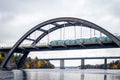 Nature autumn landscape scene with large arch concrete bridge with train crossing over calm water. Royalty Free Stock Photo