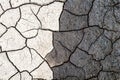 Nature background, border of dry and wet cracked mud. Concept of opposites, dark and light