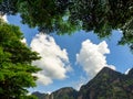 Nature background. Empty space on blue sky and white cloud background surround with green tree and mountain. Royalty Free Stock Photo