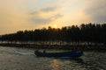 Sandy beach with harbour sunset in kerala