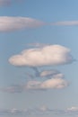 Nature background of tall cumulus clouds in evening light, blue sky and white clouds