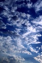 Nature background. White fluffy clouds against a dark blue sky. Vertical orientation Royalty Free Stock Photo