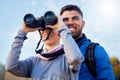 Nature, binoculars and couple hiking together for fitness, exercise and fresh air on an adventure trail. Travel, fun and Royalty Free Stock Photo