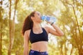 Nature, bottle and water for girl, fitness and hydration for training, workout and healthy with sports. Forest, drink Royalty Free Stock Photo