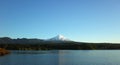 Nature of Chile, lake Villarrica and snow capped Villarrica volcano under blue sky evening light. Pucon Royalty Free Stock Photo