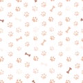 Nature colored paw prints with bones background. Seamless fabric design pattern Royalty Free Stock Photo