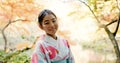 Nature, culture and portrait of Japanese woman in park for wellness, fresh air and relax outdoors. Travel, traditional