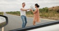 Nature, dancing and young couple on road trip in countryside listening to music together. Happy, love and man and woman Royalty Free Stock Photo