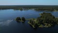 Nature eco landscape with green pines and foliar forest. Drone scenery shot across the rural lake and deciduous trees