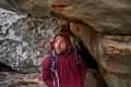 Nature, explore and man in cave, backpack and trekking in mountain or rock for adventure. Hiking, earth and male person Royalty Free Stock Photo