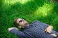 Nature fills him with freshness and inspiration. Guy relaxed peaceful enjoy freshness of grass. Man unshaven guy lay on Royalty Free Stock Photo