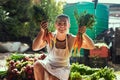 Nature always gives you more than you bargained for. Portrait of an attractive young female farmer holding a bunch of