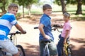 Nature, happy and portrait of kids on bicycles riding in outdoor field, park or forest for exercise. Smile, cycling and