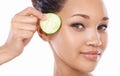 Nature is at the heart of skincare. Closeup of a gorgeous young woman holding a slice of cucumber to her face. Royalty Free Stock Photo