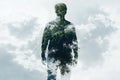 Nature and human connection: surreal double exposure of man and tree in clouds