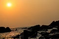the nature image of sun set near and ocean with black rocks Royalty Free Stock Photo