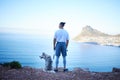 Nature, lake and man with dog in mountain for hiking, walking and fresh air together outdoors. Traveling, friendship and Royalty Free Stock Photo