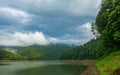 Nature landscape of green coniferous mountains above the lake on background of stormy gray clouds, rainy weather, Ukraine, Royalty Free Stock Photo