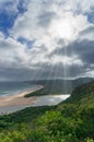 Nature landscape with ocean, beach, forest and river estuary lagoon with sun rays Royalty Free Stock Photo