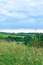 Nature landscape of purple blue and pink twilight evening sunset at rural village green field Royalty Free Stock Photo