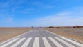 Nature landscape view of straight road in under sunny blue sky in Dunhuang UNESCO Global Geopark, Gansu China