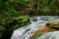 Nature landscape. Waterfall. Beautiful fall mountain wild Forest waterfall with green moss cover stones. Forest autumn landscape. Royalty Free Stock Photo