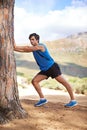 Nature, man or runner stretching legs for fitness training, wellness or exercise outdoors by a tree. Relax, muscle Royalty Free Stock Photo