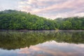 Nature mirror world wallpaper, soft pink sunset over the river with green hill and cloudy sky