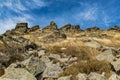 Nature mountain ridge landscape poster of rocky top scenic view and grass land ground with vivid blue sky background space Royalty Free Stock Photo