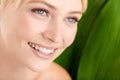 Nature and natural beauty. Closeup shot of a beautiful young woman standing against a leafy green background.