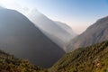 Nature in Nepal, high mountains with a trees in a shadow on a blue sky background. Royalty Free Stock Photo