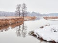 Nature of Northern Europe, lake, early spring, light fog, reflection in the water. Royalty Free Stock Photo