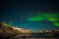 Nature of Norway. Aurora Borealis in Tromso, Norway in front of the Norwegian fjord, winter season, long shutter speed Royalty Free Stock Photo