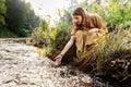 Woman or witch performing magic ritual on river