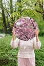 woman with cherry tree reflection in round mirror Royalty Free Stock Photo