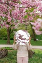 woman with cherry tree reflection in round mirror Royalty Free Stock Photo