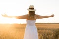 Happy woman in straw hat on cereal field in summer Royalty Free Stock Photo