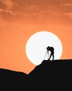 Nature photographer silhouettes at sunset on the hill