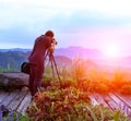 Nature photographer taking photos in the mountains Royalty Free Stock Photo