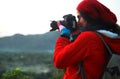 Nature photographer taking pictures during hiking trip