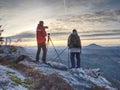 Nature photographers in red and light jacket take photo Royalty Free Stock Photo