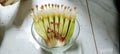 the tip of a banana fruit that is still a baby flower whole on bowl