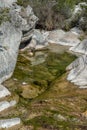 Nature with a river of mineral water and surrounded by gray rocks and green vegetation and plants Royalty Free Stock Photo