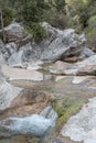 Nature with a river of mineral water and surrounded by gray rocks and green vegetation and plants Royalty Free Stock Photo